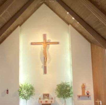 A cross on a wall

Description automatically generated